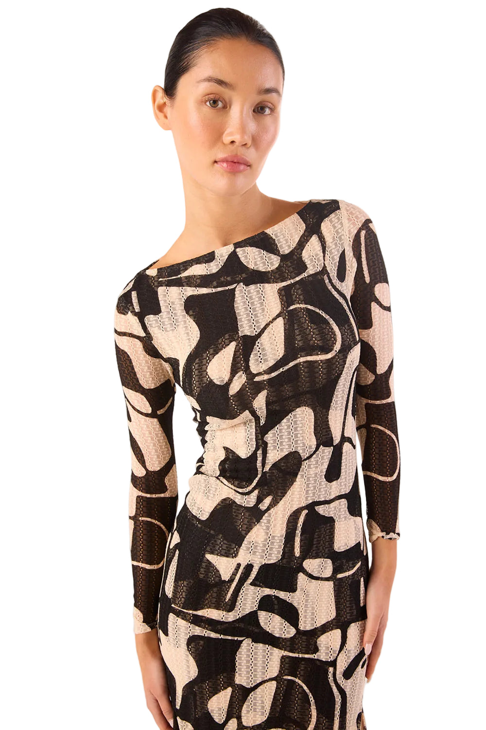Woman wearing a black and beige patterned dress on a white background