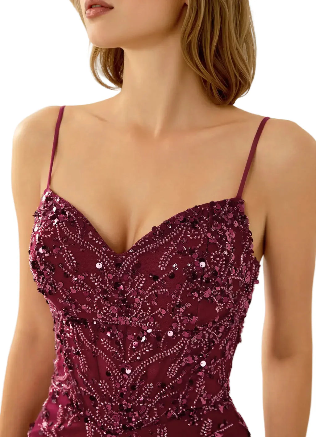 Close-up of a person wearing a burgundy sequin dress with thin straps.