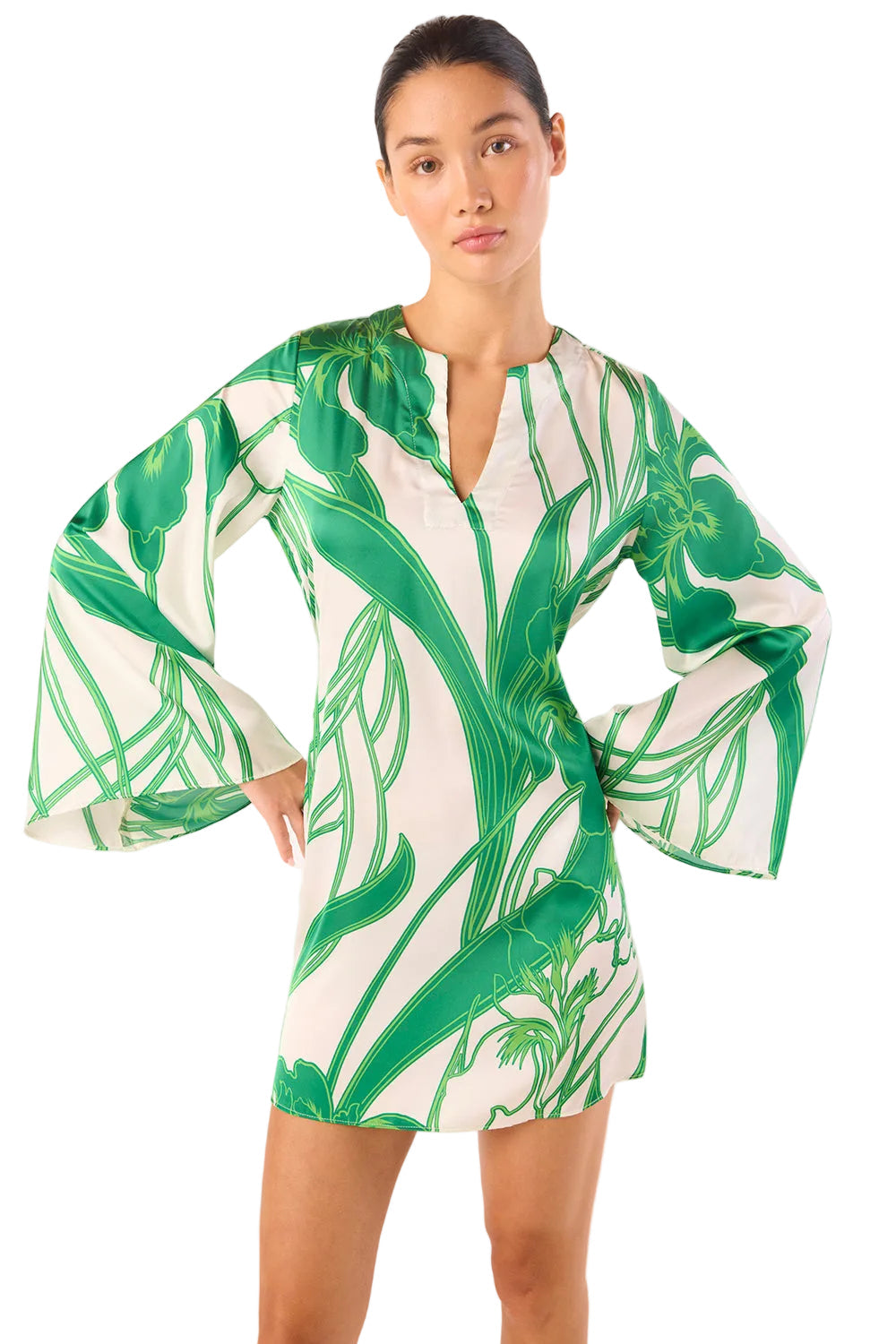 Woman wearing a green and white leaf-patterned dress on a white background