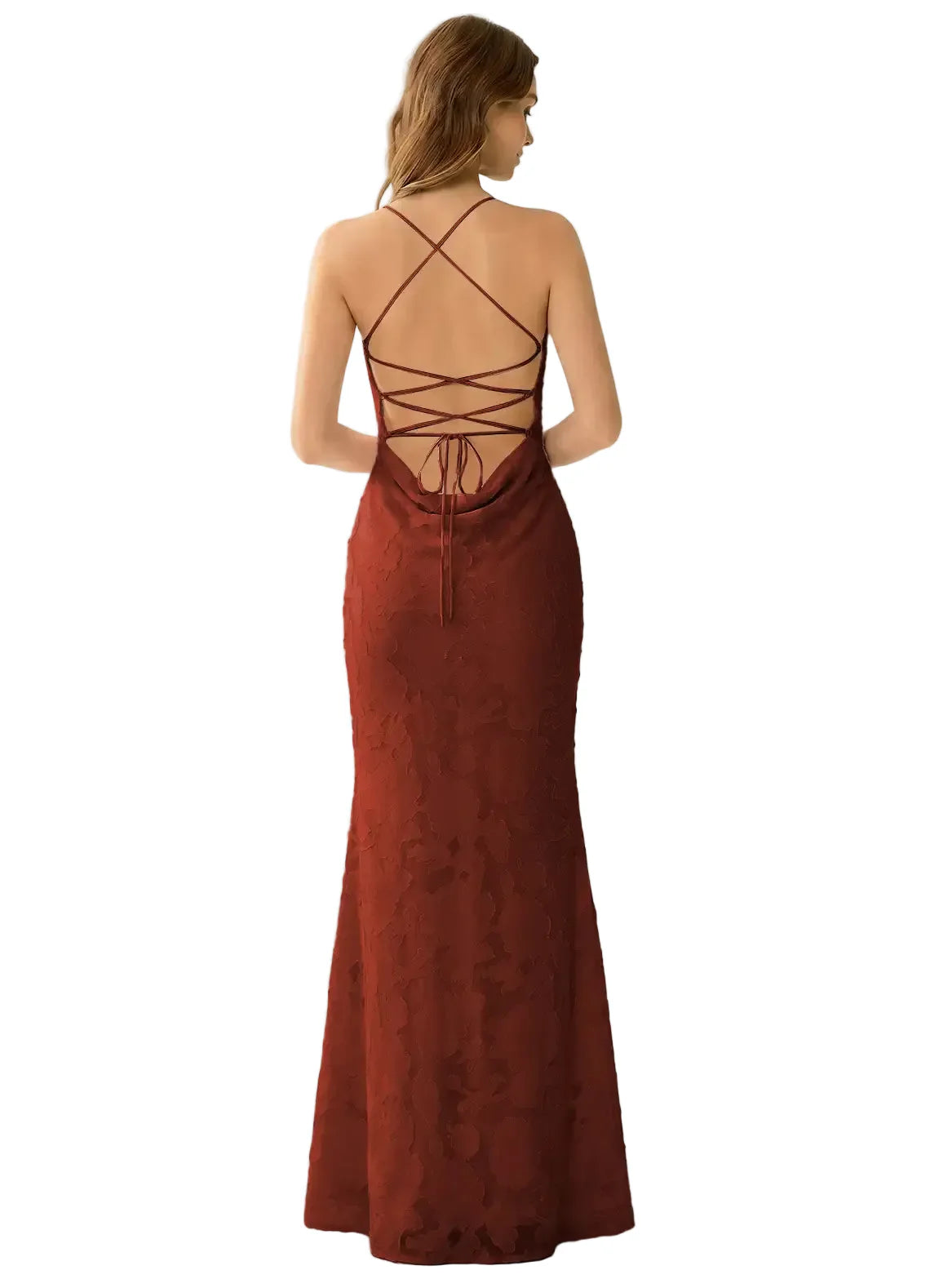 Woman wearing a rust-colored evening gown with a backless design on a white background