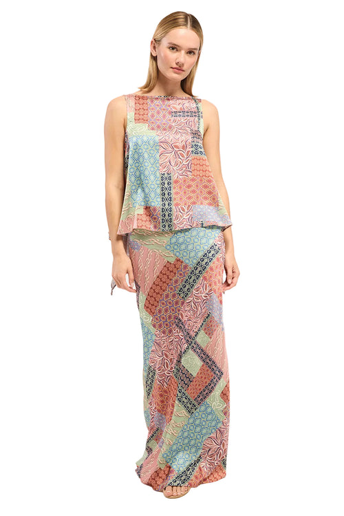 Woman wearing a colorful patchwork dress on a white background