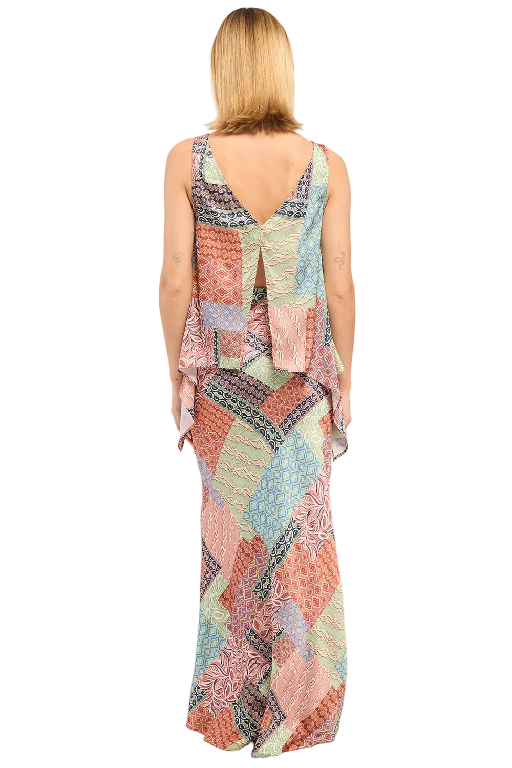 Woman wearing a colorful patchwork dress on a white background