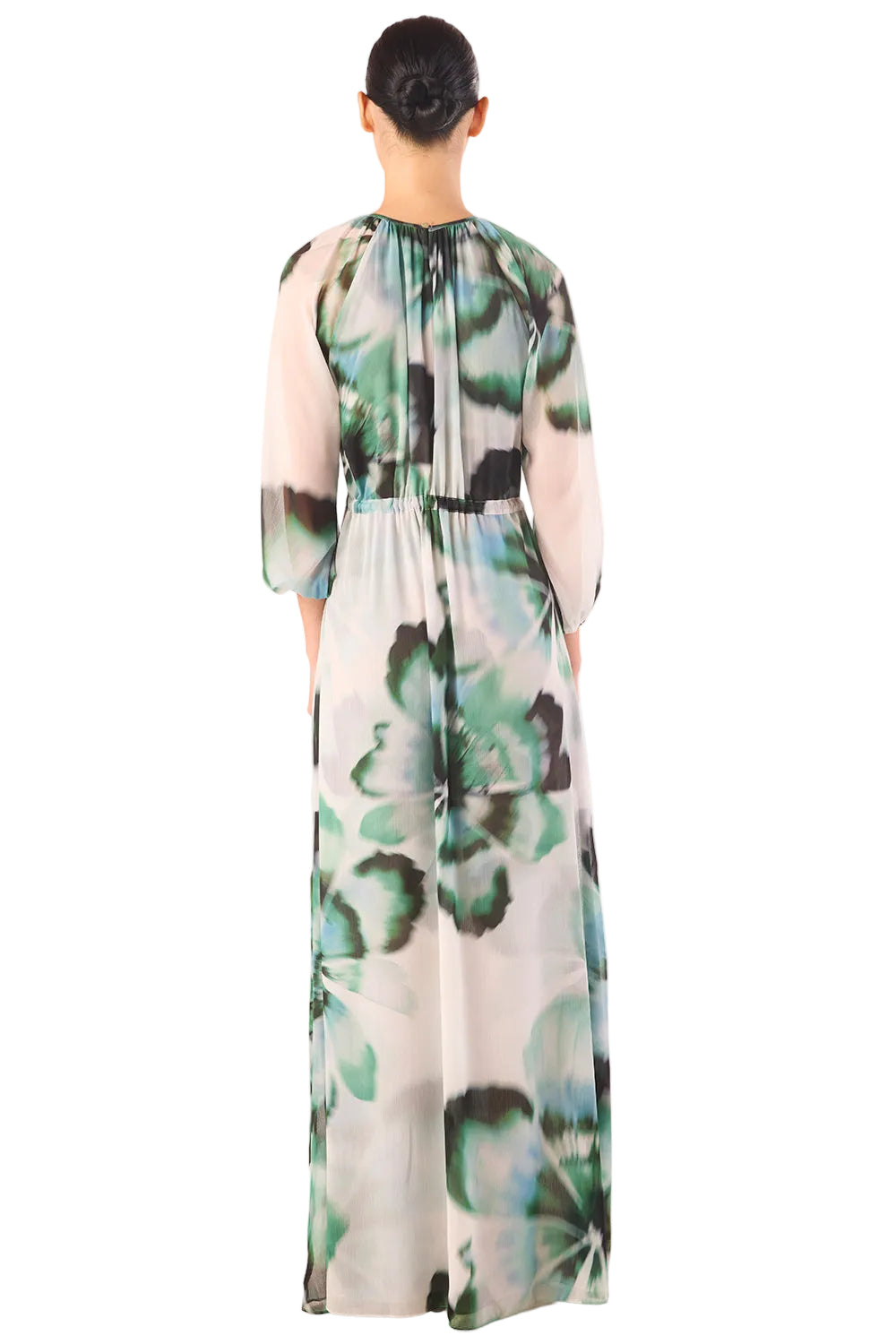 Woman wearing a floral dress with long sleeves on a white background