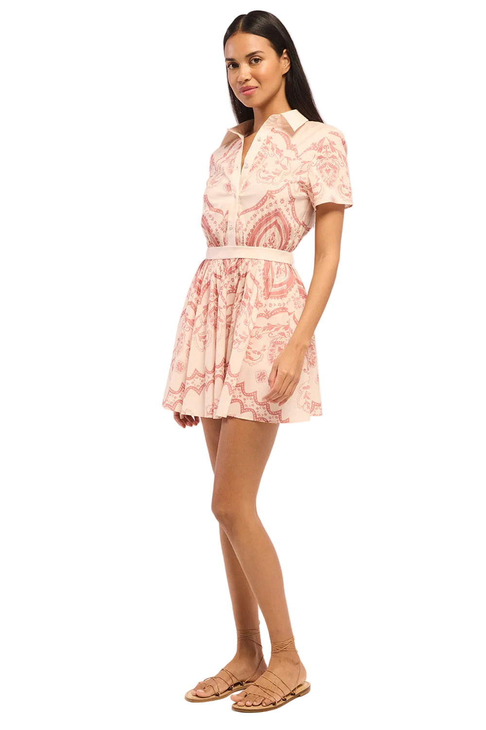Woman wearing a pink patterned dress on a white background