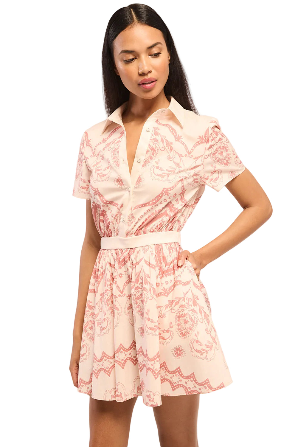 Woman wearing a pink patterned dress on a white background